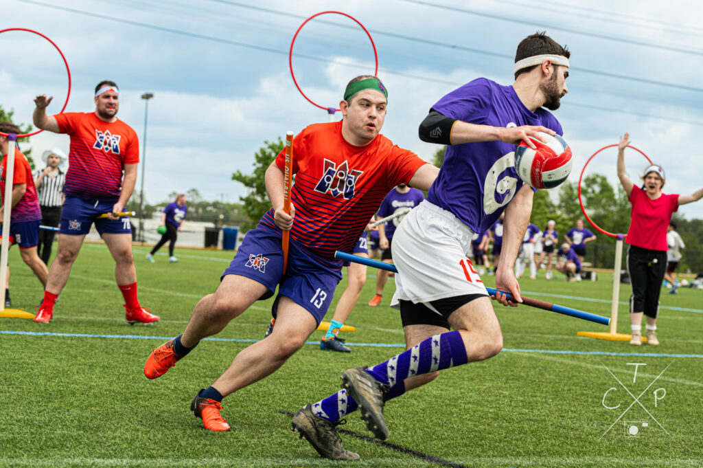 Players compete during a Quadball match, showcasing the sport’s mix of speed, strategy, and inclusivity. Photo by Tom Chiddy Powers.