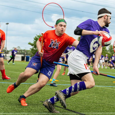Players compete during a Quadball match, showcasing the sport’s mix of speed, strategy, and inclusivity. Photo by Tom Chiddy Powers.